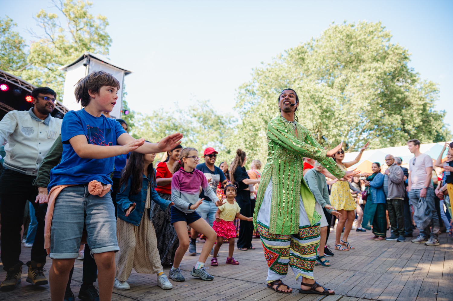 A crowd of all ages dancing together at an Indian dance celebration in Ghent